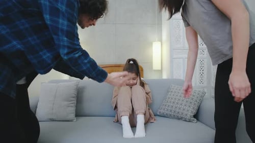 Sad Girl Sitting on Couch Hugging Knees