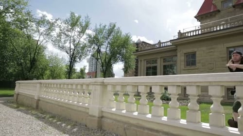 Young Man Vaulting Over Wall in Urban Park