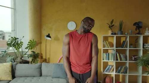 Man stretching neck muscles indoors for fitness