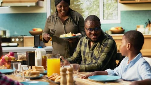 Family Enjoying a Meal Together in Kitchen Setting