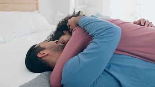 Loving Couple Cuddling in Bed Together