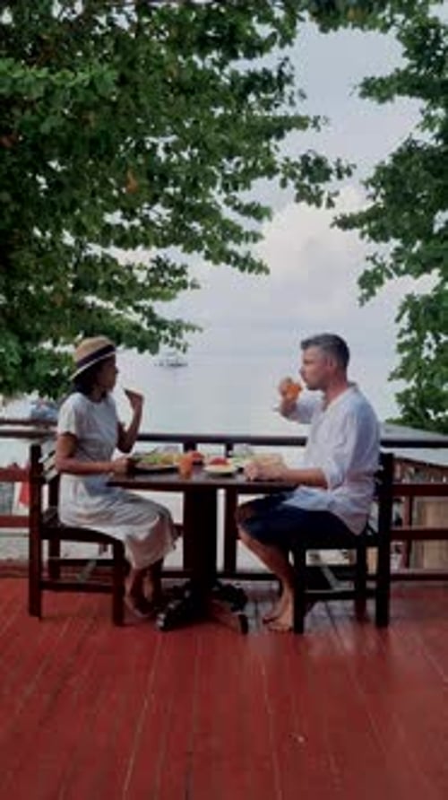 Couple of Men and Women Having Breakfast on the Balcony During a Vacation in Thailand