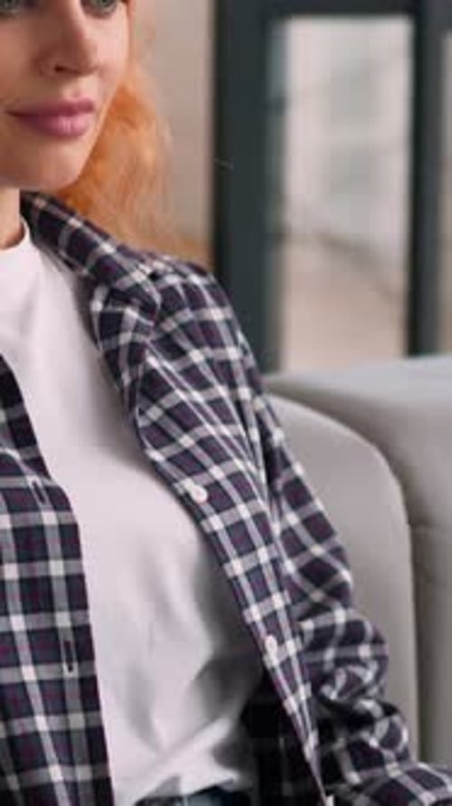 Young Woman Working on Laptop on Gray Couch