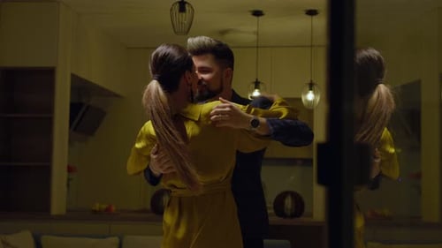 Stylish Couple Dancing Intimately in Warmly Lit Home