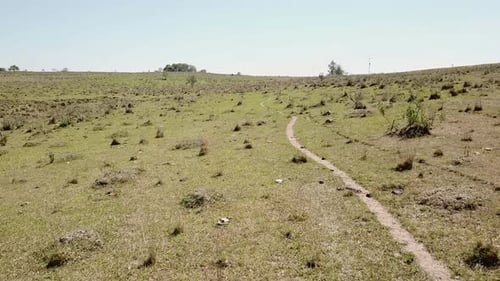 Slow drone shot of a trail in the countryside.Footpath.