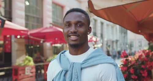 Close up portrait of young african american man which posing on camera with sincerely smile