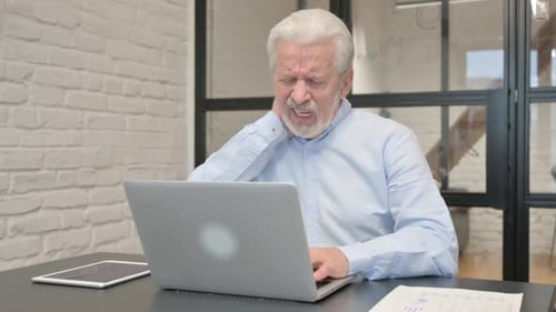 Senior Man Experiencing Neck Pain While Working on Laptop