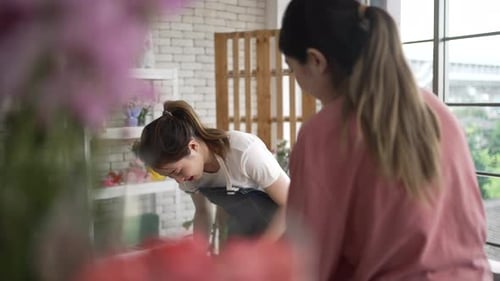 Young entrepreneurs are working at florist shop.