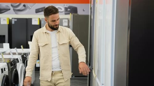 Customer Choosing Discounted Refrigerator in Electronics Store