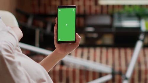Hand Holding Smartphone with Green Screen Mockup