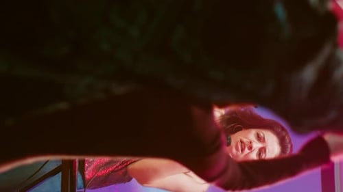 Woman Singing Karaoke at Night in Lively Urban Venue