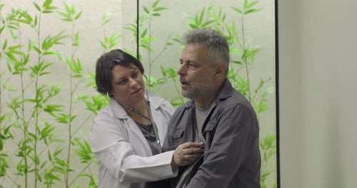 Doctor Examines Patient in Office with Stethoscope