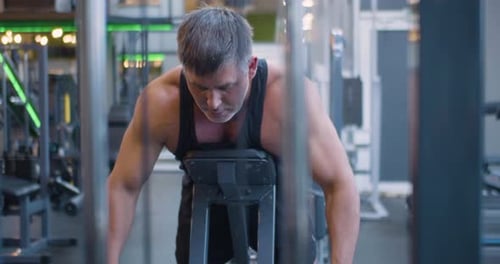 Gym Workout Back Exercise Middle Aged Caucasian Man Trains His Back Muscles in the Gym