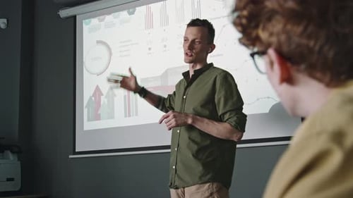 Businessman Explaining Financial Presentation to Colleagues on Office Meeting