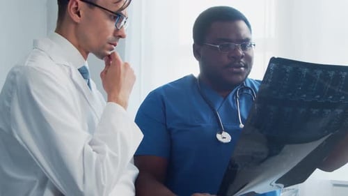 Doctor and Surgeon Talking Near Window Medical Workers in Hospital Office Day Light Healthcare