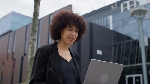 Young Woman Video Conferencing Outside Office Building