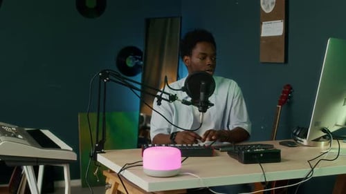 Male Sound Engineer Recording Voice Using Smart Gadgets at Home Studio