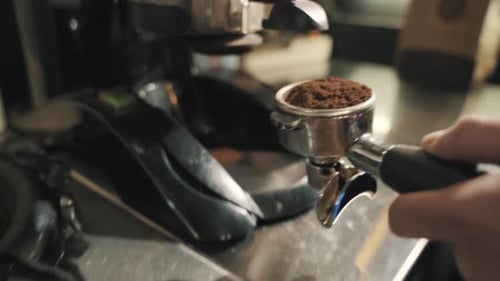 Grinding coffee beans using a high-quality coffee grinder, captured with a close-up