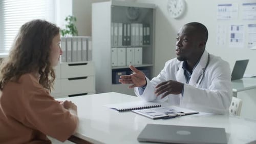 African American Doctor Explaining Diagnosis to Patient in Medical Office