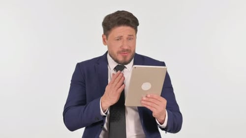 Worried Man Reads Tablet News in Studio