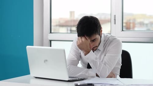 technology, business - busy manager at computer makes a gesture of annoyance
