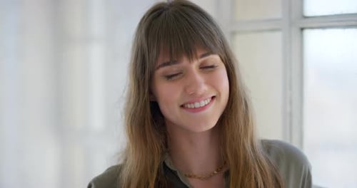 Attractive Young Woman Smiles and Looks at Camera