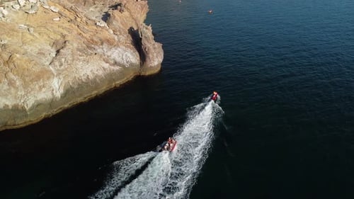Watercrafts Speeding Across Water, Coastal Aerial View