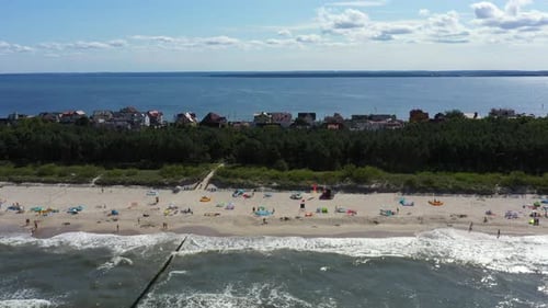 Baltic Sea coast beach Hel aerial drone top view 4K UHD video. People on the beach. Aerial View