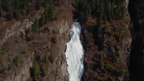 Frozen Waterfall Cascading Down Mountain Cliffside, Aerial View