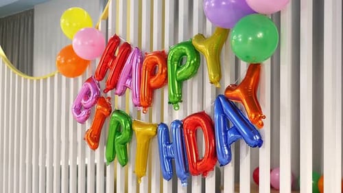 Colorful Garland of Helium Balloons with the Words Happy BIRTHDAY