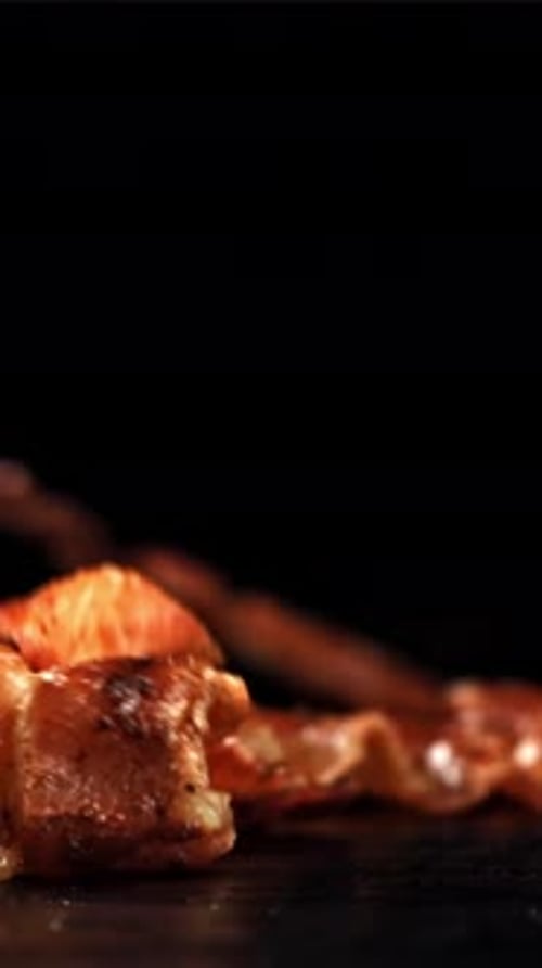 Bacon Falling on a Black Background Filmed on a Highspeed Camera at 1000 Fps
