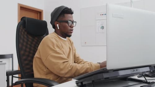 Young Black Programmer Working In Office