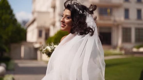 Smiling Bride Holding Out Her Hand in Invitation