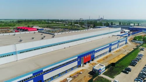 Production Plant Facade and Cars on Parking Lot Aerial View
