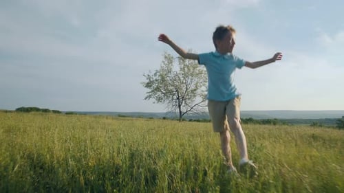 Child Jumping Freely in a Sunny Green Field Front Angle of Joy