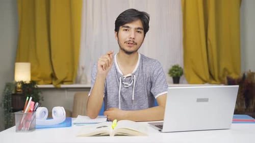 Young Adult Working at Desk Explaining Something