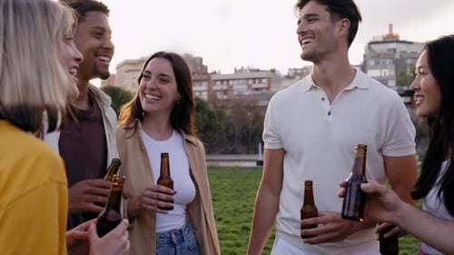 Group of Friends Drinking Beer Having Fun in a Party at the Park Having Fun in This Celebration