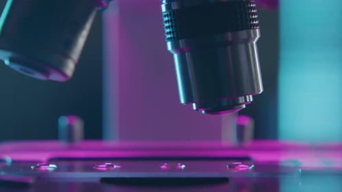 Close Up Microscope Objective Lens Turning over Glass Slide with Specimen