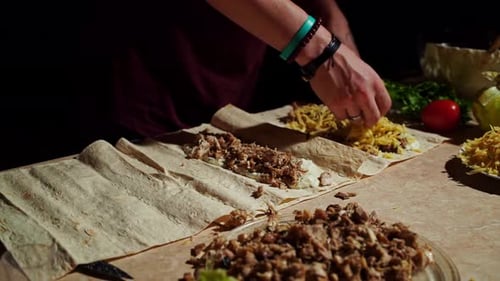 Hands Preparing Delicious Tortilla Wrap with Meat
