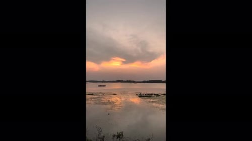 traditional fishing boats lines the lake's edge, their colorful hulls reflecting in the calm water.