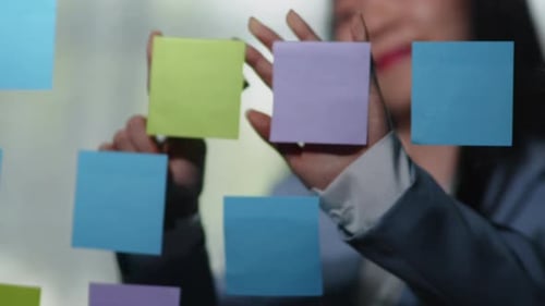 Brainstorming Session with Colorful Sticky Notes on Glass