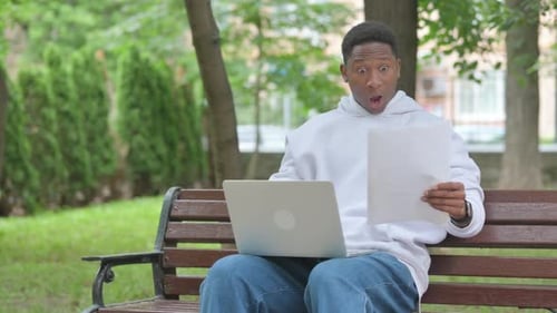 Happy Man Working on Laptop Outdoors
