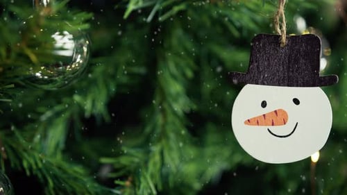 Festive Christmas Tree with Snowman Ornament and Snow