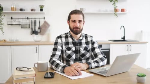 Man Sitting at Table Giving Ok Sign