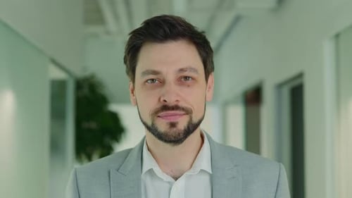 Handsome Smiling Businessman Standing in Office Looking at Camera Posing Business Portrait