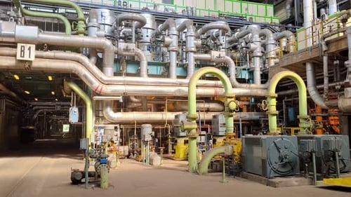 Engine room of a coal-fired power plant, with extensive and piping, establishing pan