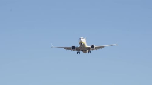 Passenger airplane lands smoothly on airport runway in bright daylight