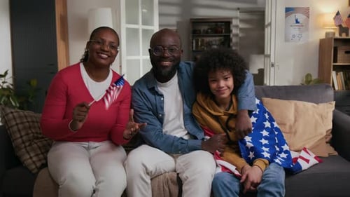 Family Portrait of Mother, Father and Gen Alpha Son on Independence Day at Home
