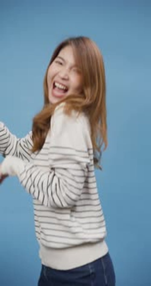 Excited Woman Dancing and Celebrating in Studio