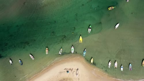Small Fishing Boats anchored in a shallow lagoon, with packed Fish net onboard, Aerial view